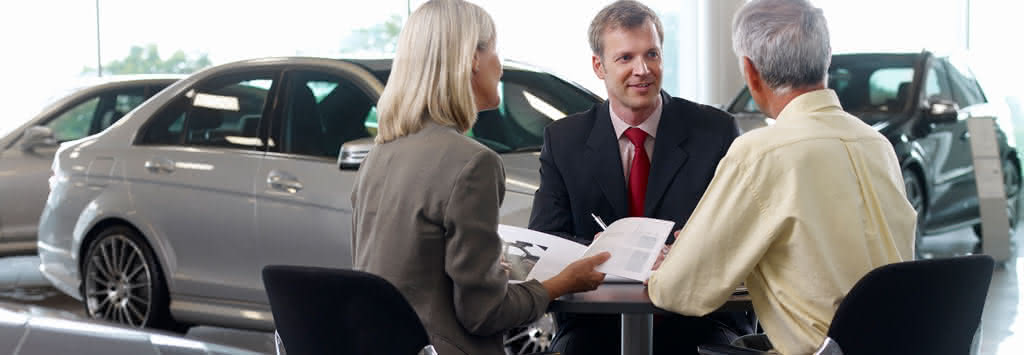 Gente discutiendo c&oacute;mo funcionan los pr&eacute;stamos para autom&oacute;viles